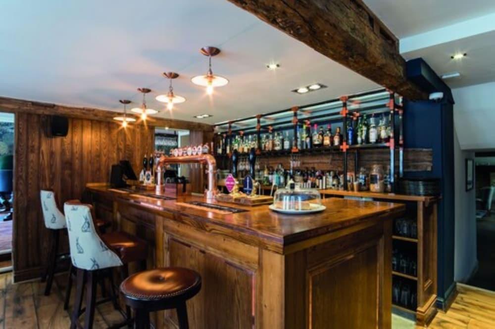 The Fleece At Сайренстер Экстерьер фото The bar at The Old Dispensary